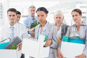 Unhappy fired business people holding box