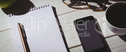 Overhead shot of notepad and smartphone