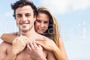 Happy couple in swimsuit embracing