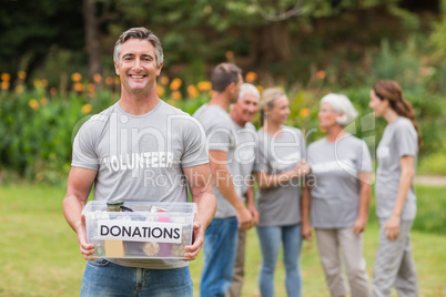 Happy man holding donations boxes