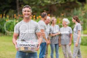 Happy man holding donations boxes