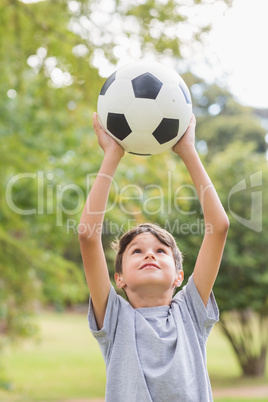 Boy holding a soccer ball in the park