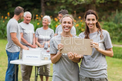 Happy volunteer family holding donation boxes