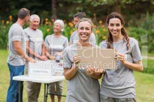 Happy volunteer family holding donation boxes