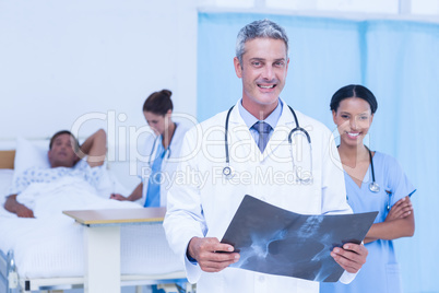 Doctor with colleague and patient behind