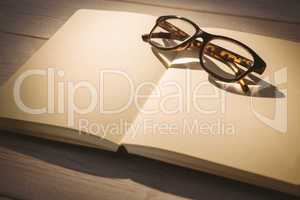 Empty notepad with reading glasses