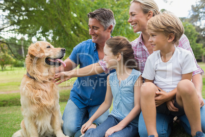 Happy family in the park with their dog
