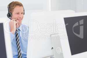 Handsome agent with headset typing on keyboard