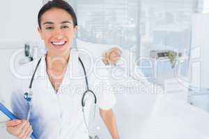 Smiling doctor looking at camera in patients room