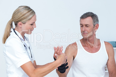 Doctor examining a man wrist