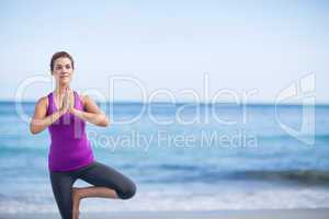 Brunette doing yoga on exercise mat