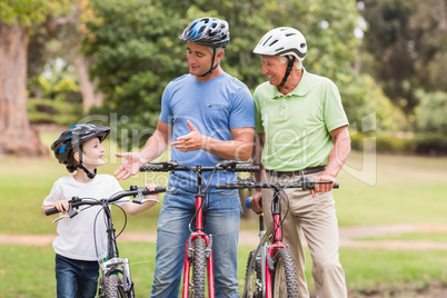 Happy multi generation family on their bike at the park