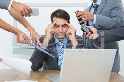 Worried businessman with head in hands