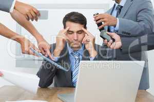 Worried businessman with head in hands