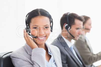 Business people with headsets using computers