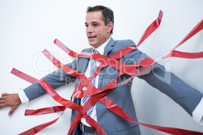 Businessman trapped by red tape