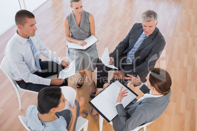 Business team sitting in circle and discussing