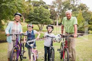 Happy grandparents with their grandchildren on their bike