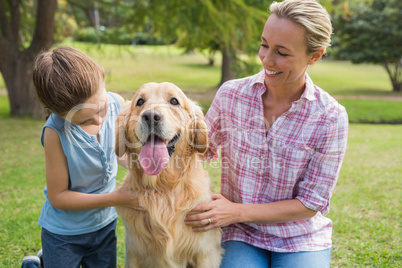 Mother and her daughter with their dog in the park