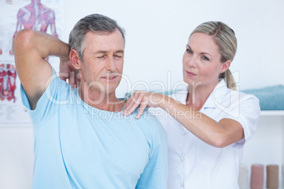 Doctor stretching a man arm Doctor stretching a man arm