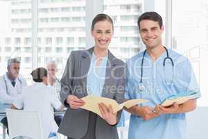 Male and female doctors with reports