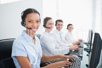 Business people with headsets using computers