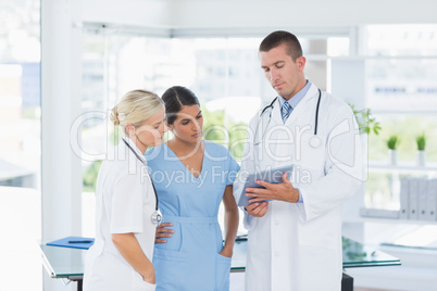 Doctors looking together at tablet