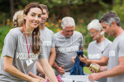 Happy volunteer looking at donation box