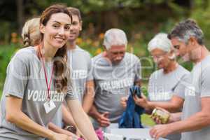 Happy volunteer looking at donation box