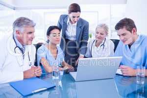 Team of doctors and businesswoman having a meeting