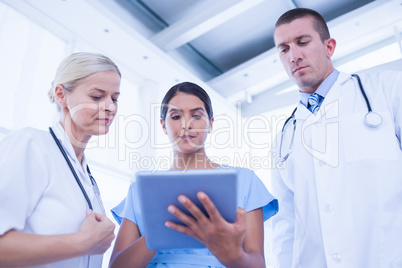 Doctors looking together at tablet