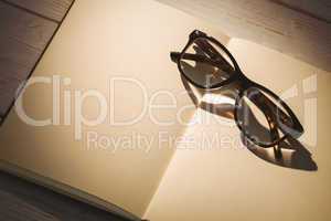 Empty notepad with reading glasses