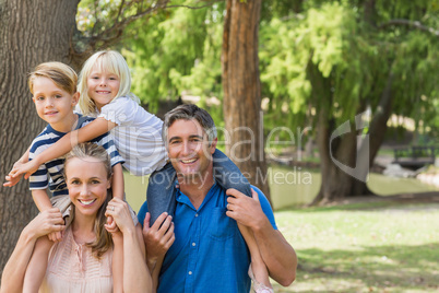 Happy family playing in the park together