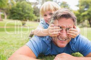 Happy father and his son smiling at camera