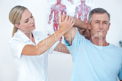 Doctor stretching a man arm