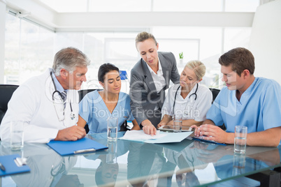 Team of doctors and businesswoman having a meeting