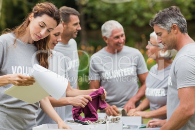 Happy volunteer looking at donation box