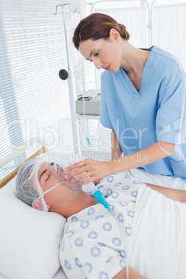 Doctor holding patients oxygen mask