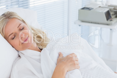 Happy patient lying on her bed