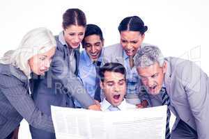 Surprising business people looking at newspaper
