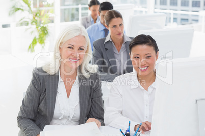 Smiling work team using computer