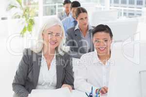 Smiling work team using computer