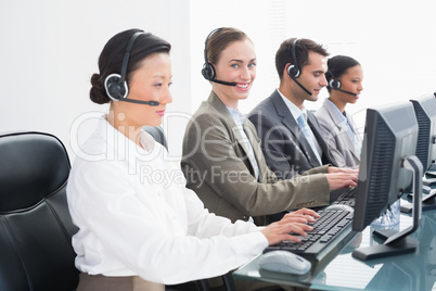 Business people with headsets using computers