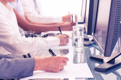 Close up view of business people writing on paper