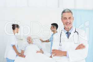 Doctor with colleagues and patient behind