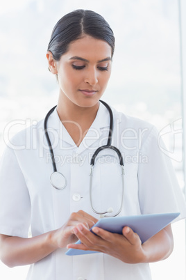 Doctor writing on clipboard