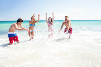Happy friends having fun in the water together Happy friends having fun in the water together