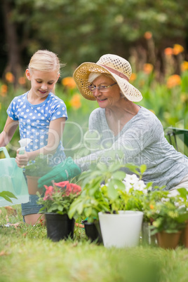 Happy grandmother with her granddaughter gardening