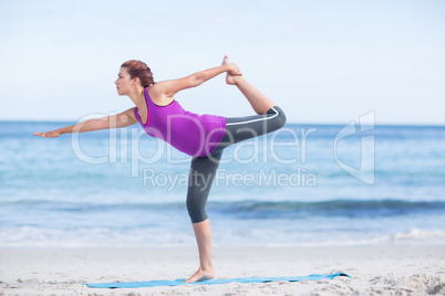 Brunette doing yoga on exercise mat