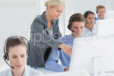 Manager helping call centre employee